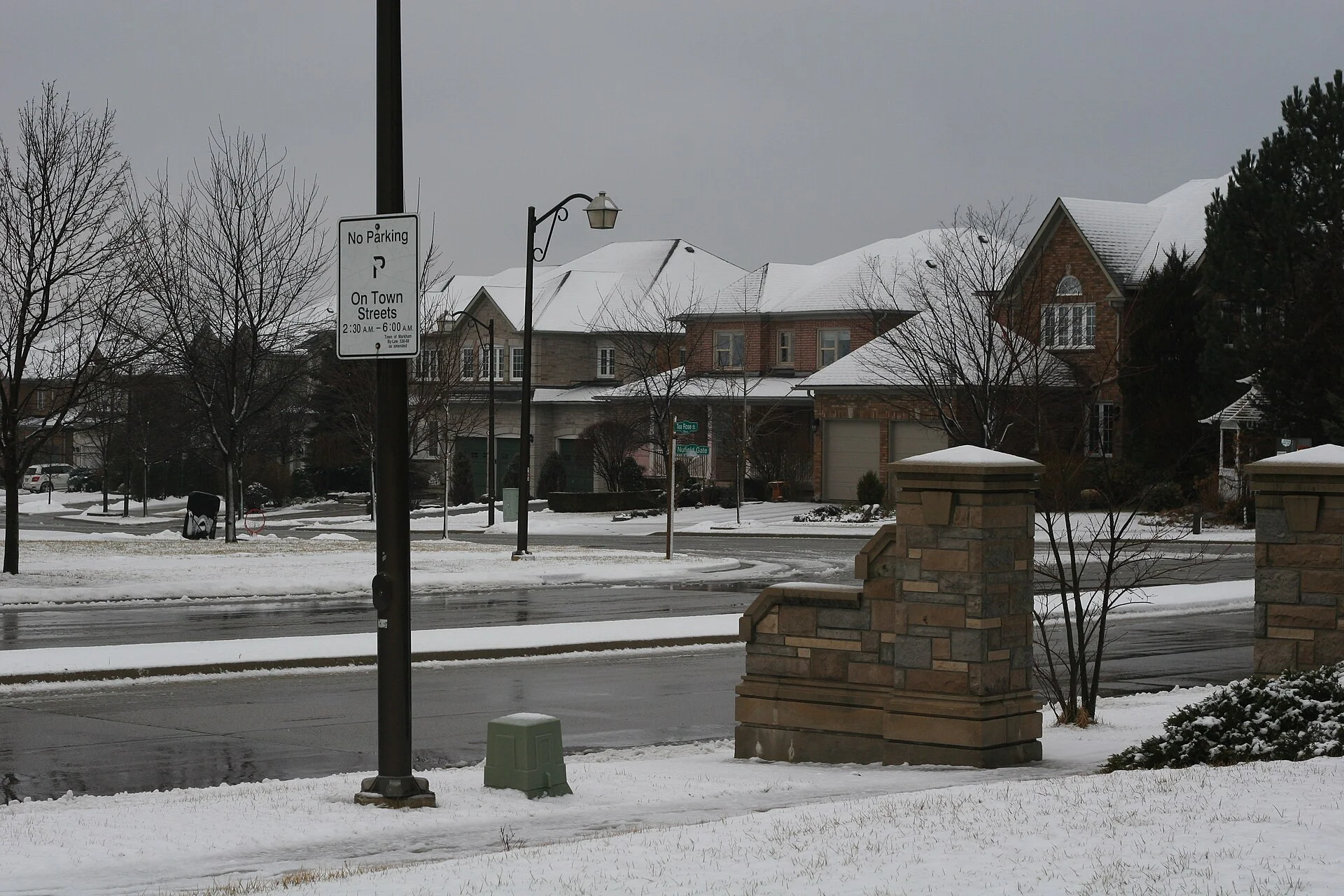 Snow-covered lawns and brick homes along Tea Rose Street in Markham's Upper Unionville neighbourhood on a grey winter day