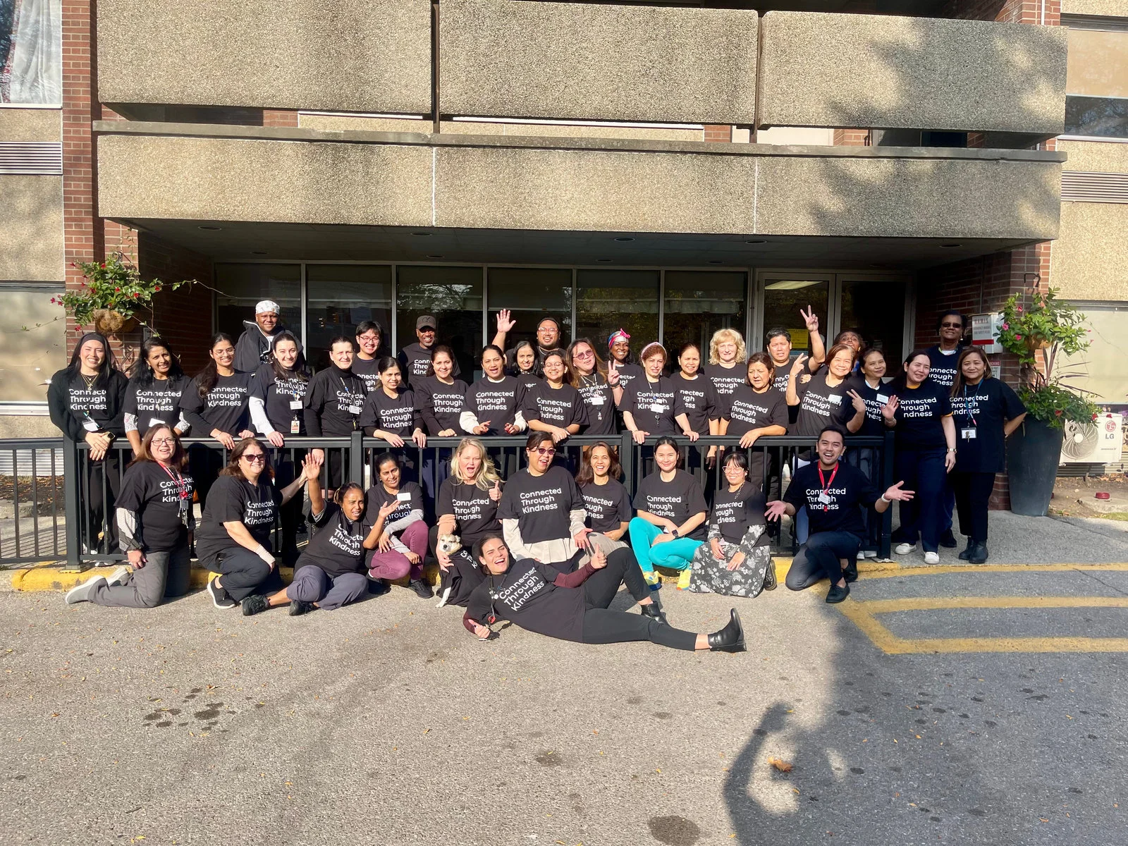 Staff of Cooksville Care Centre gather outside the entrance of the long-term care home