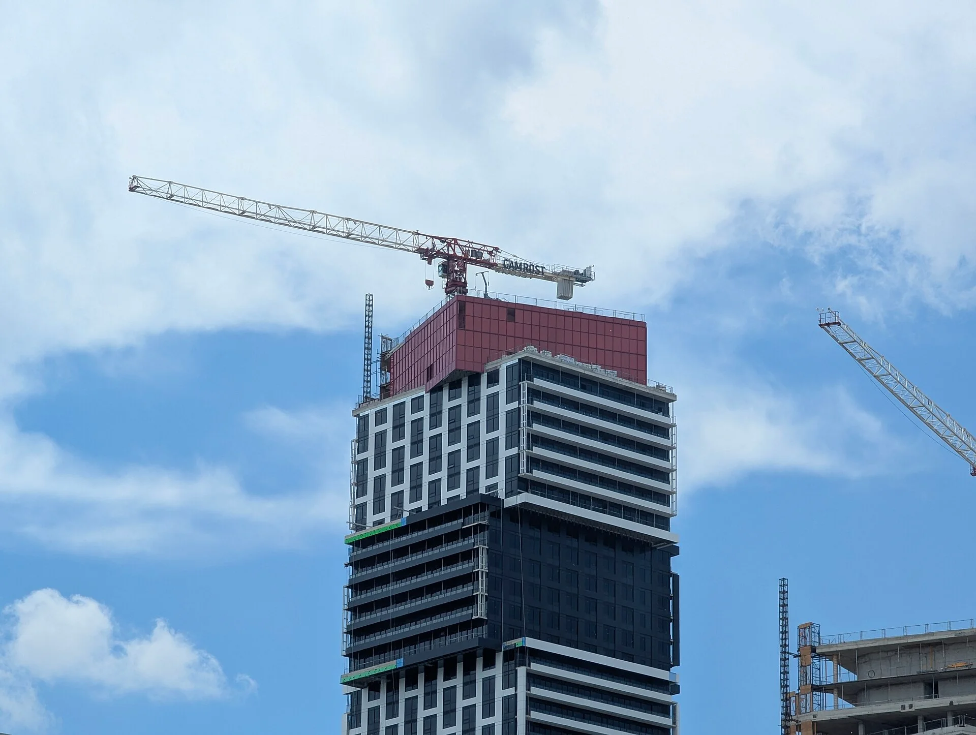 A tower crane atop a high-rise residential building under construction in Mississauga's Exchange District
