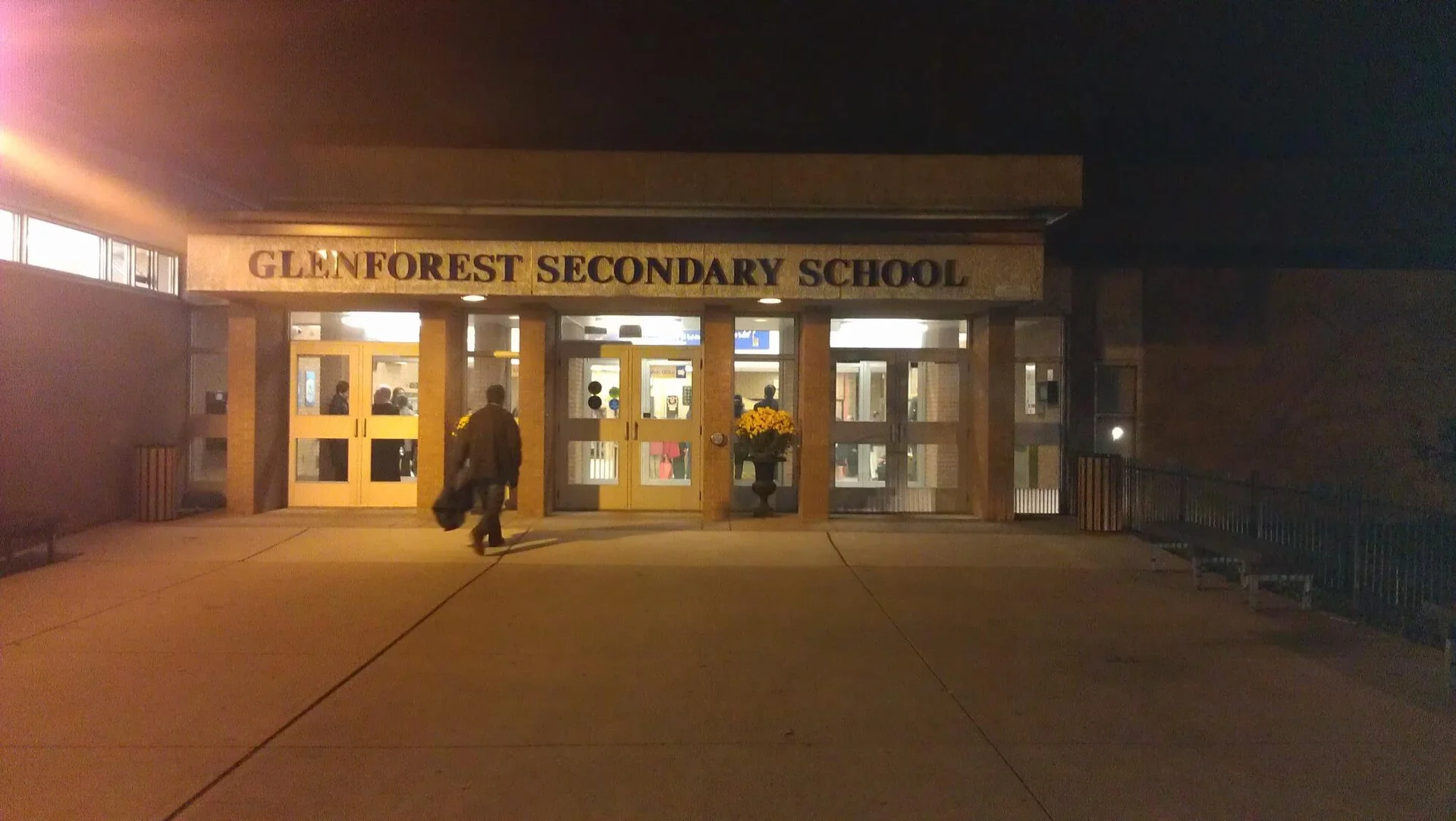 The lit front entrance of Glenforest Secondary School in Mississauga at night