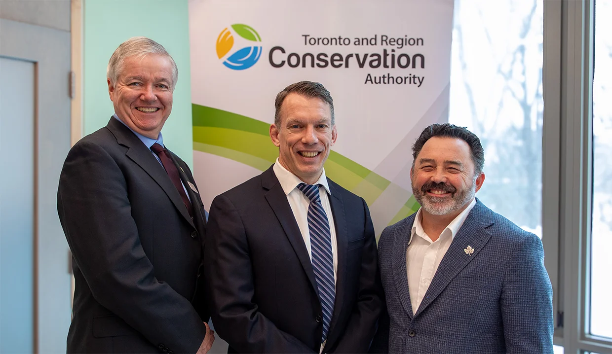 Vice-chair Paul Ainslie, chief executive John MacKenzie and chair Dave Barton stand in front of a TRCA banner