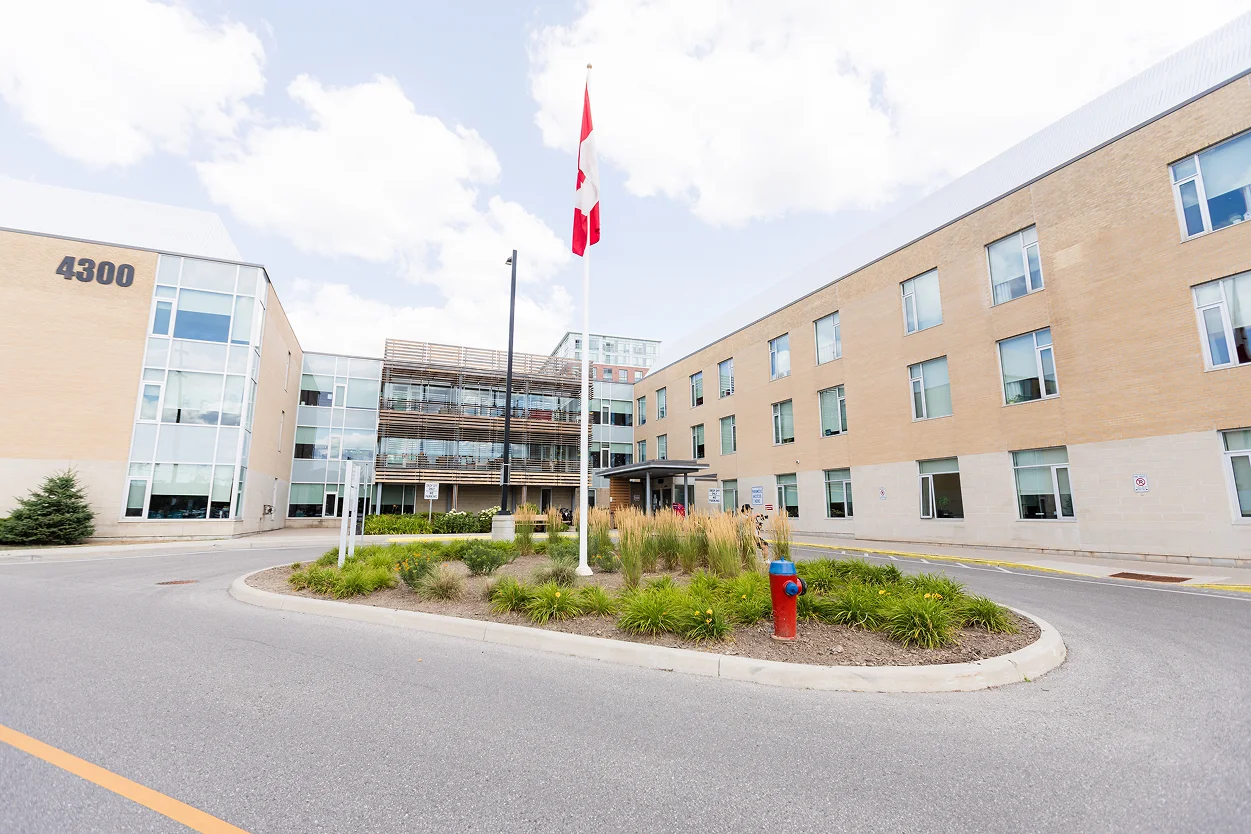 The front entrance of Union Villa long-term care home in Unionville, with a Canadian flag over a circular garden
