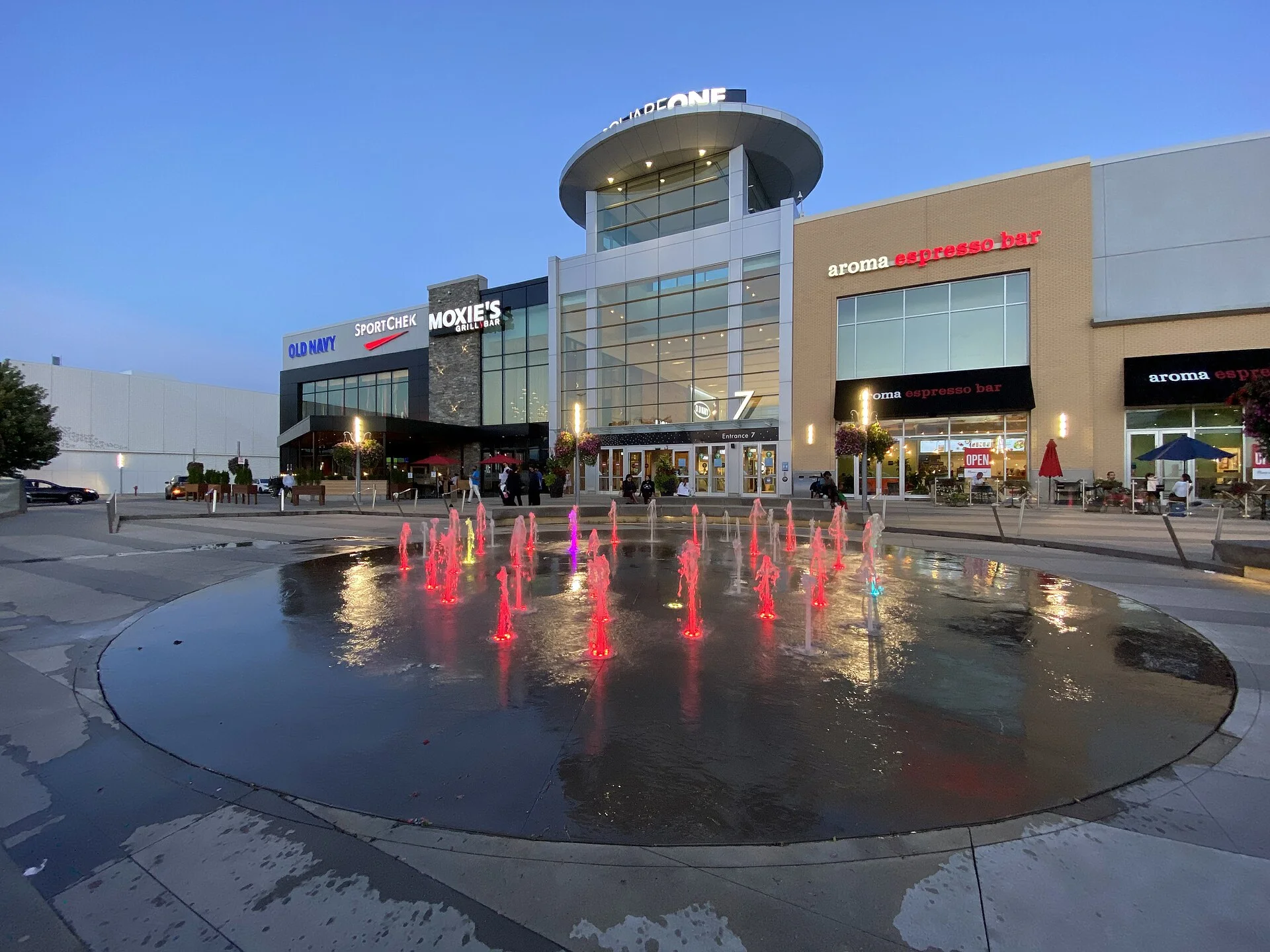 Entrance 7 of Square One Shopping Centre at dusk, with a lit fountain in the foreground