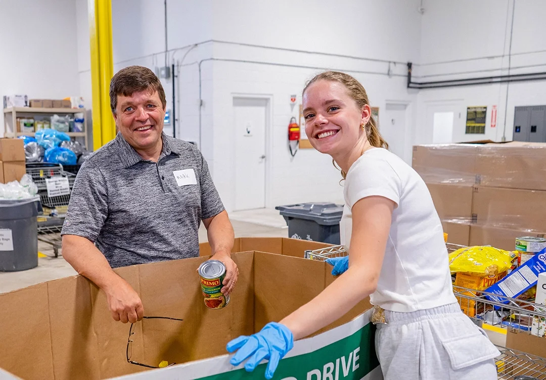 Volunteers sort donated food into bins at the Food Banks Mississauga warehouse