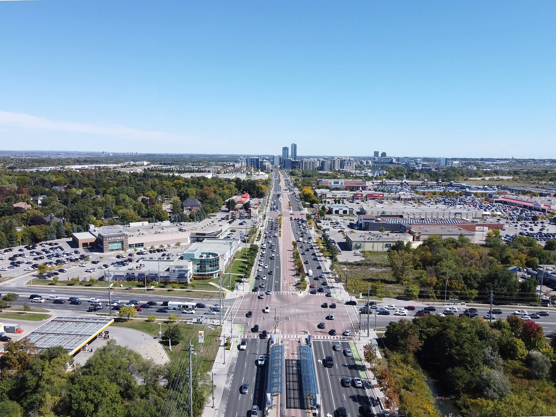 Aerial view of Highway 7 in Markham at Woodbine Avenue, with the Viva rapidway down the middle and towers on the horizon