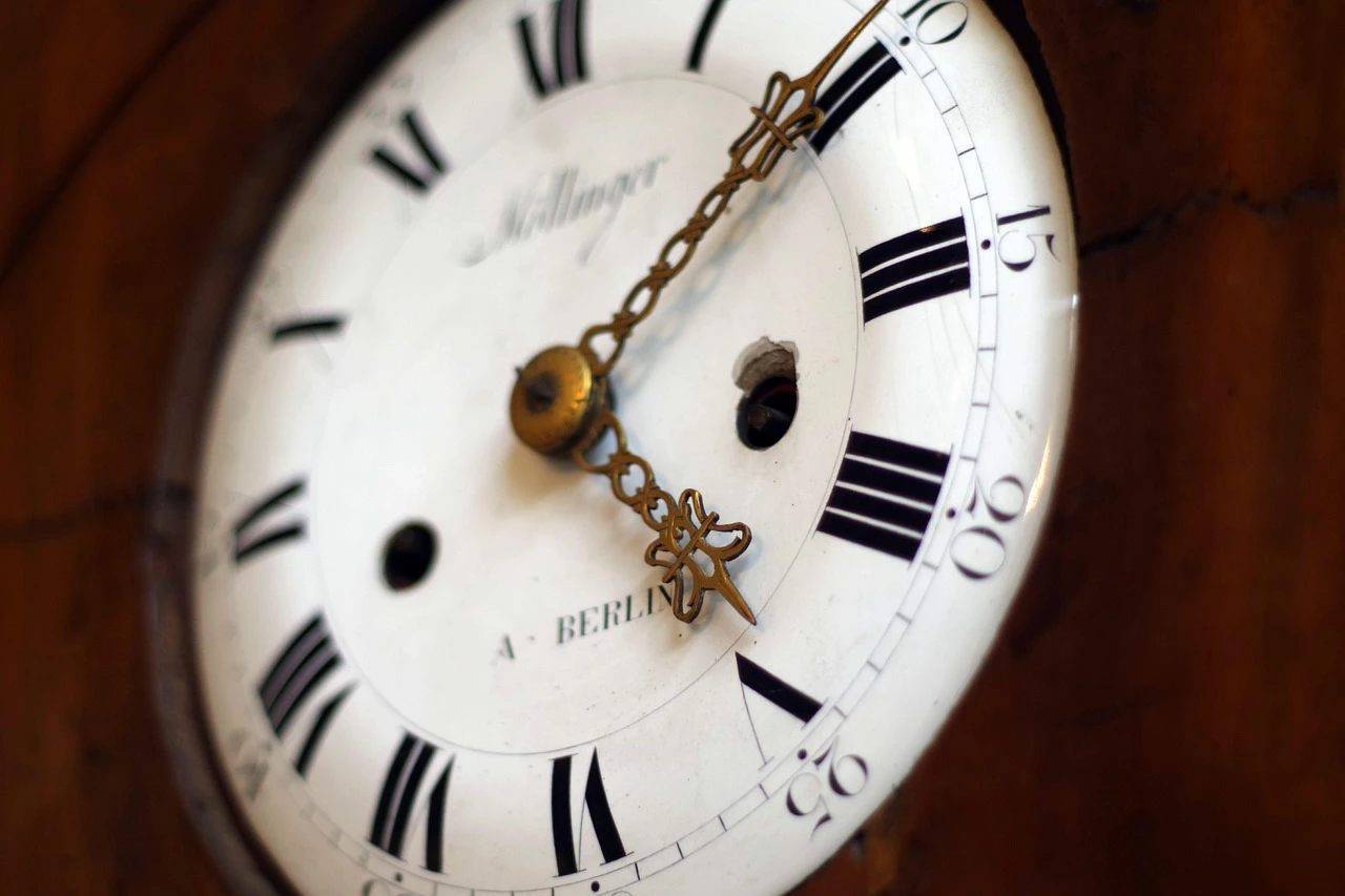 An analog wall clock showing 2:00, with soft morning light hitting the room.