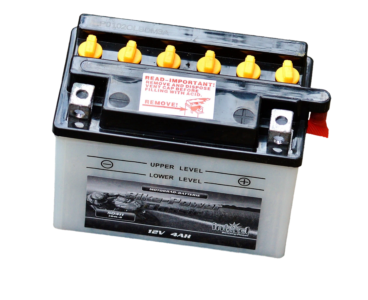 A close-up of various used household batteries resting on a wooden surface.