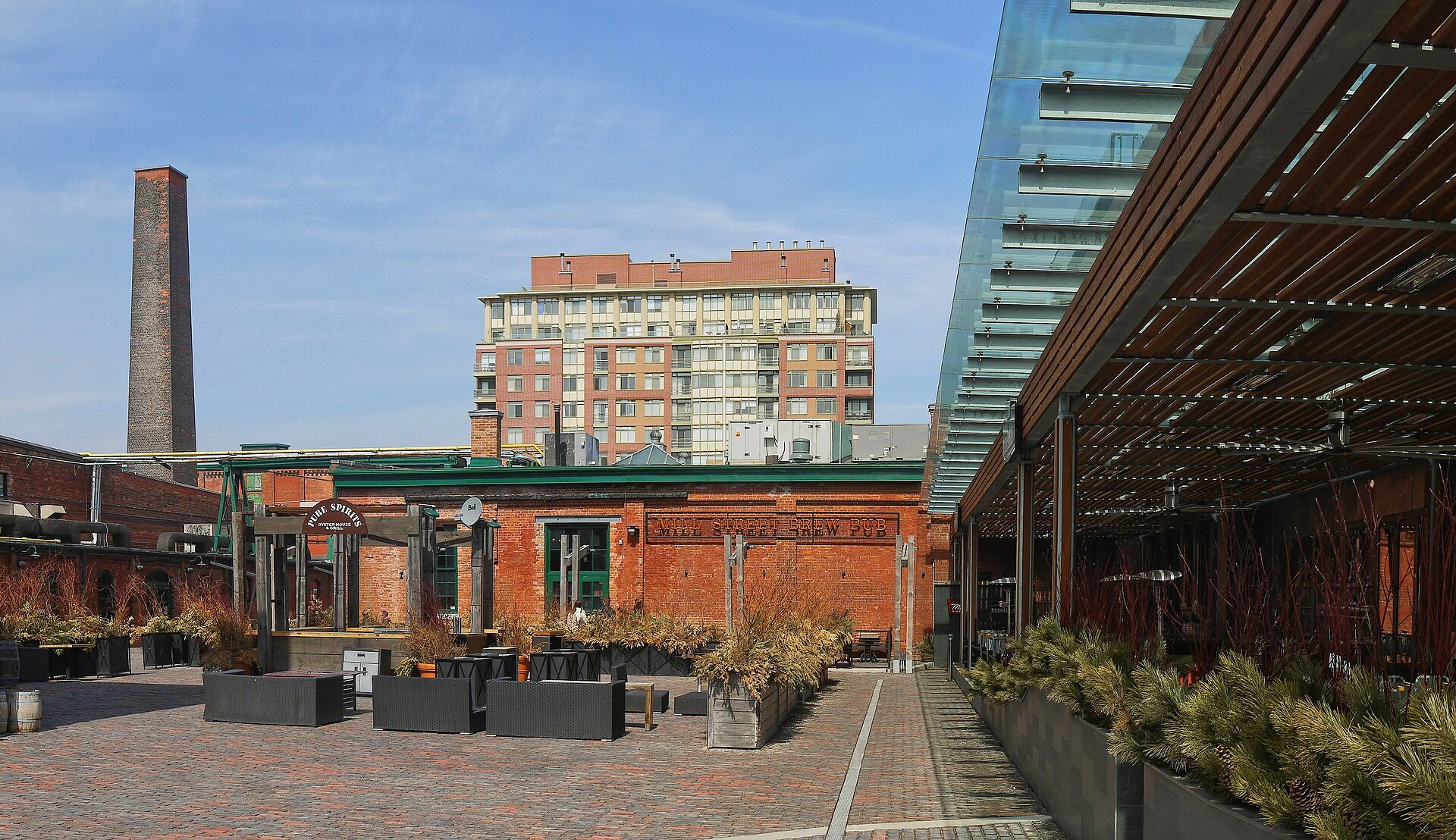 A view of the historic brick buildings and cobblestone streets of the Distillery District in Toronto during a summer evening.