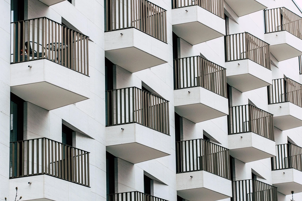 A modern mid-rise apartment building on a Toronto residential street in autumn.