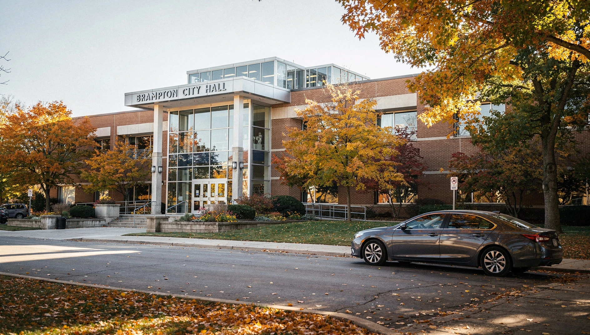 A wide shot of the Brampton City Hall exterior under an autumn sky.