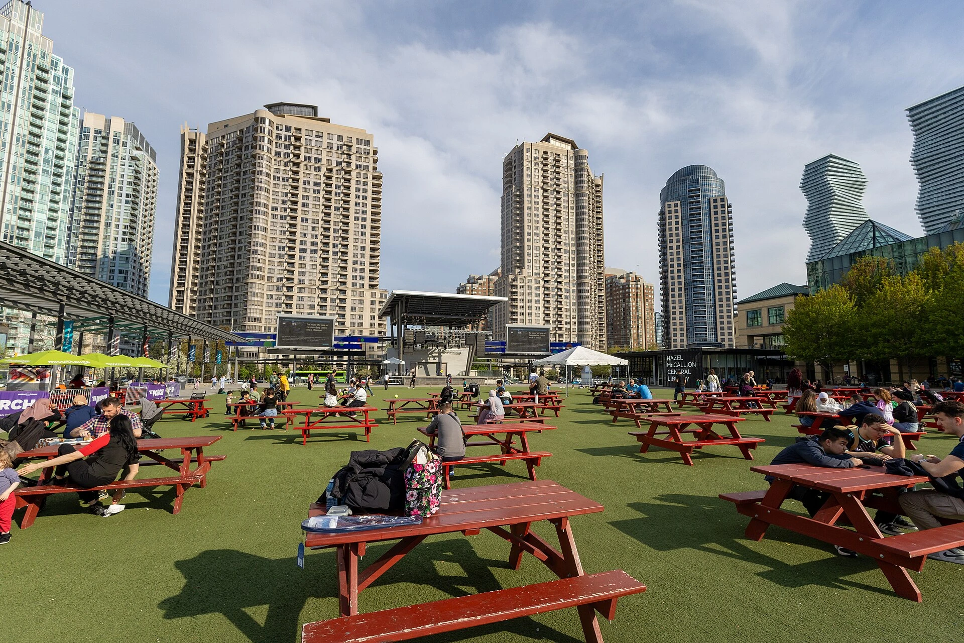 Illustration of a Mississauga civic square with an outdoor screen and fresh green trees.