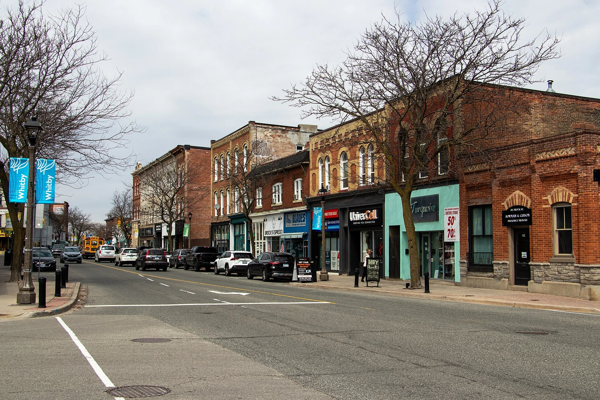 Illustration of a pedestrian-friendly summer street festival in a downtown area, with vendor tents, patios and strollers on a closed street.