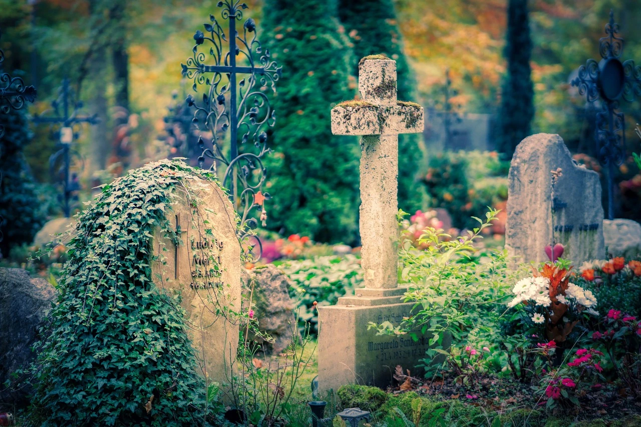Illustration of an Ontario cemetery in autumn with gravestones decorated with lanterns, flowers and shepherd hooks.