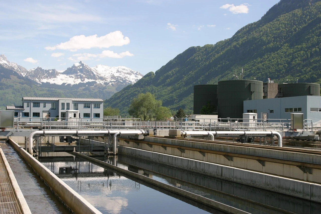 A close-up shot of a large industrial metal pipe inside a municipal wastewater treatment facility.