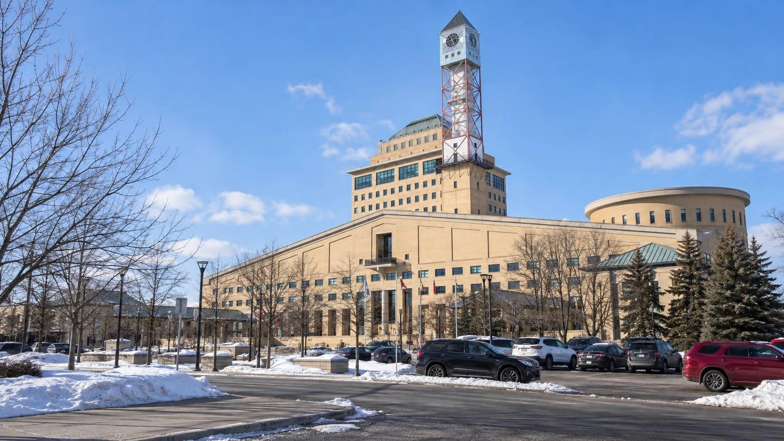 The exterior of the Mississauga Civic Centre on a bright, snowy winter day.