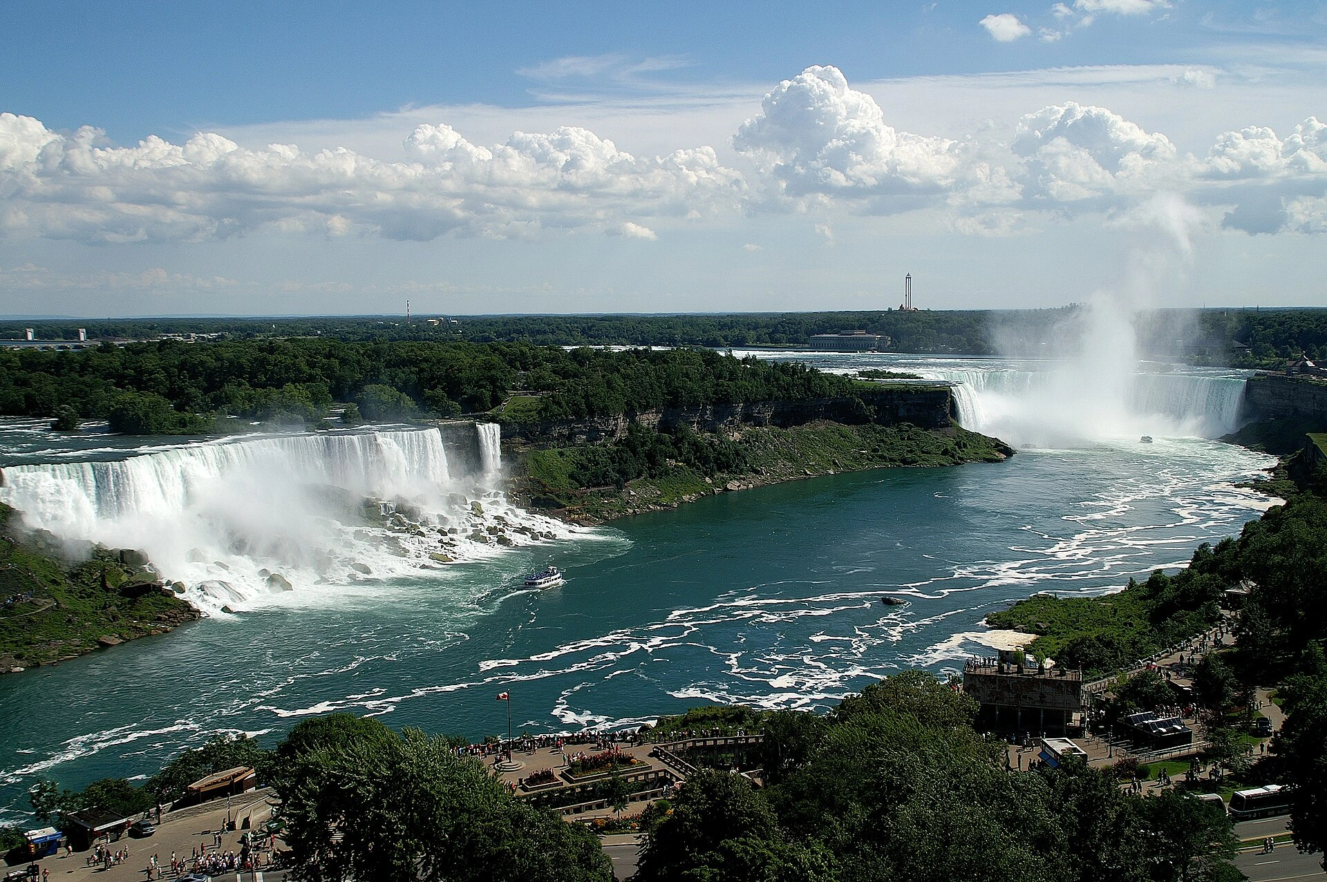 Niagara Falls hotel towers seen through autumn foliage with a Canadian flag