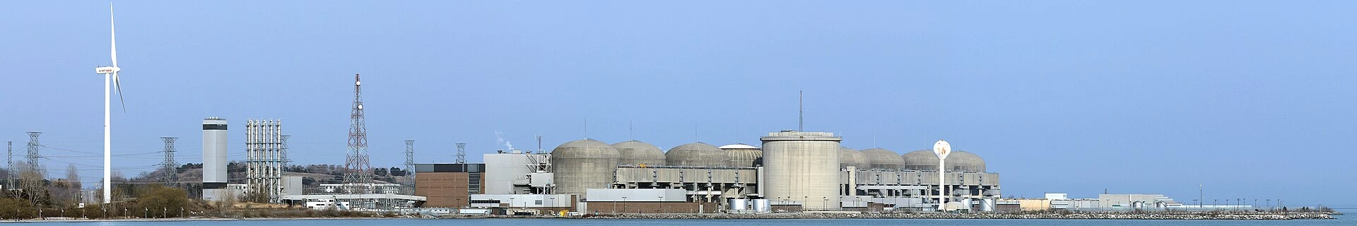 The Pickering Nuclear Generating Station's reactor buildings along the Lake Ontario shoreline on an overcast autumn day.