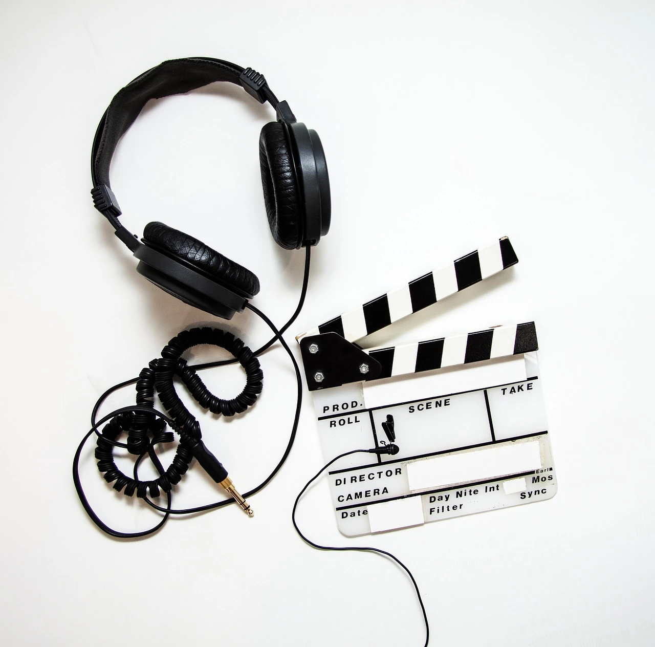 A professional video production setup with a digital camera on a tripod and studio lighting in a modern workspace.