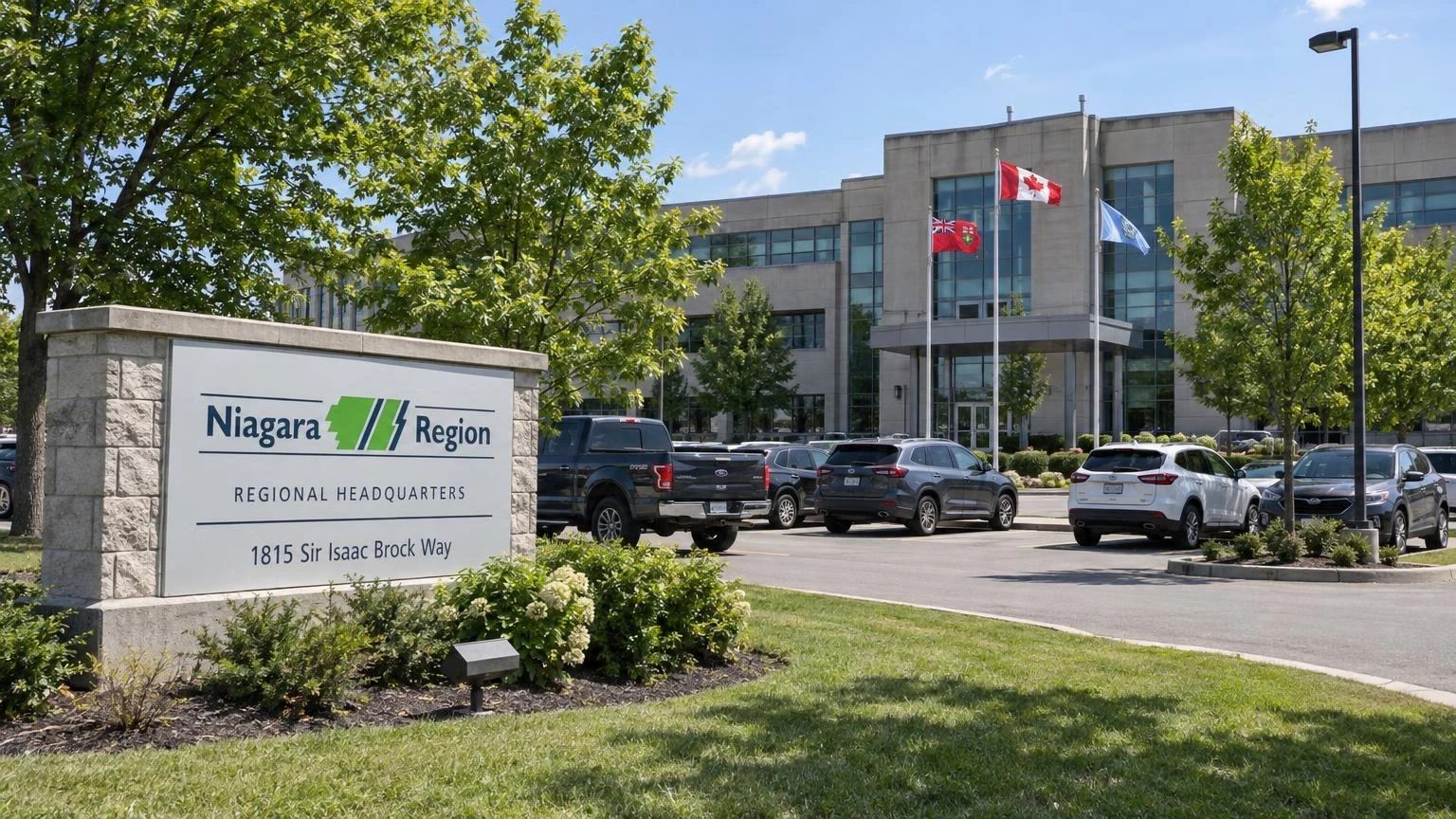 An exterior view of a municipal government building in Ontario under a clear summer sky.