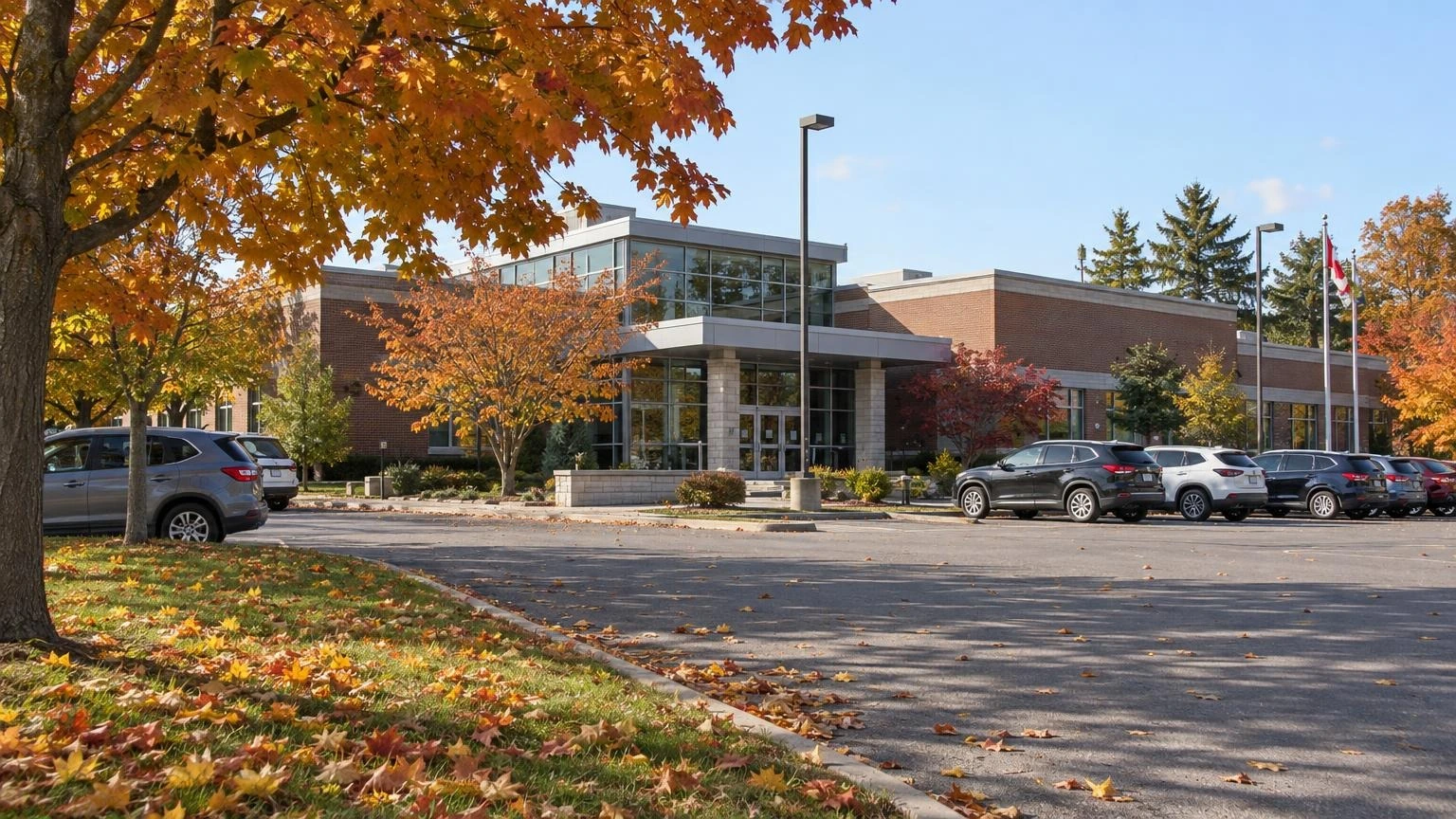An exterior view of a modern municipal building in Ontario during autumn.