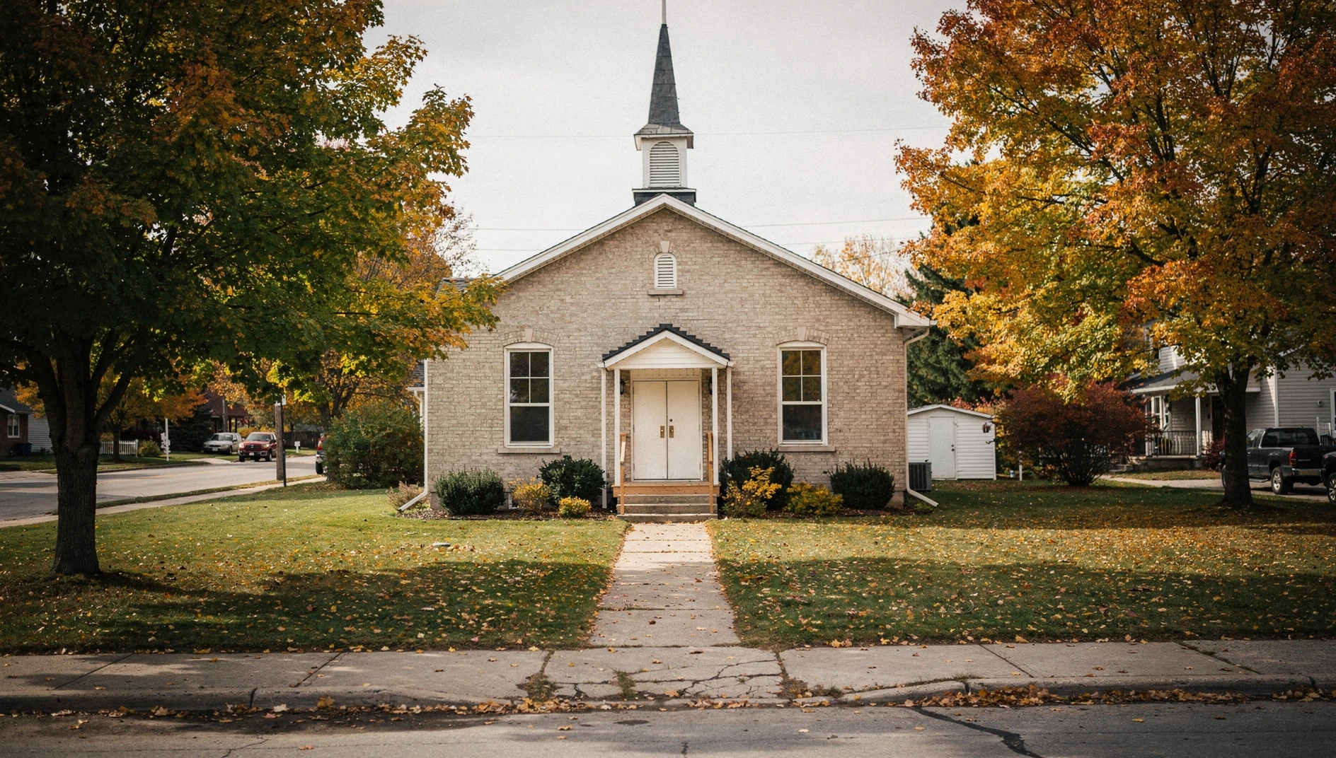 Illustrative view of a church exterior in Bolton framed by autumn trees.