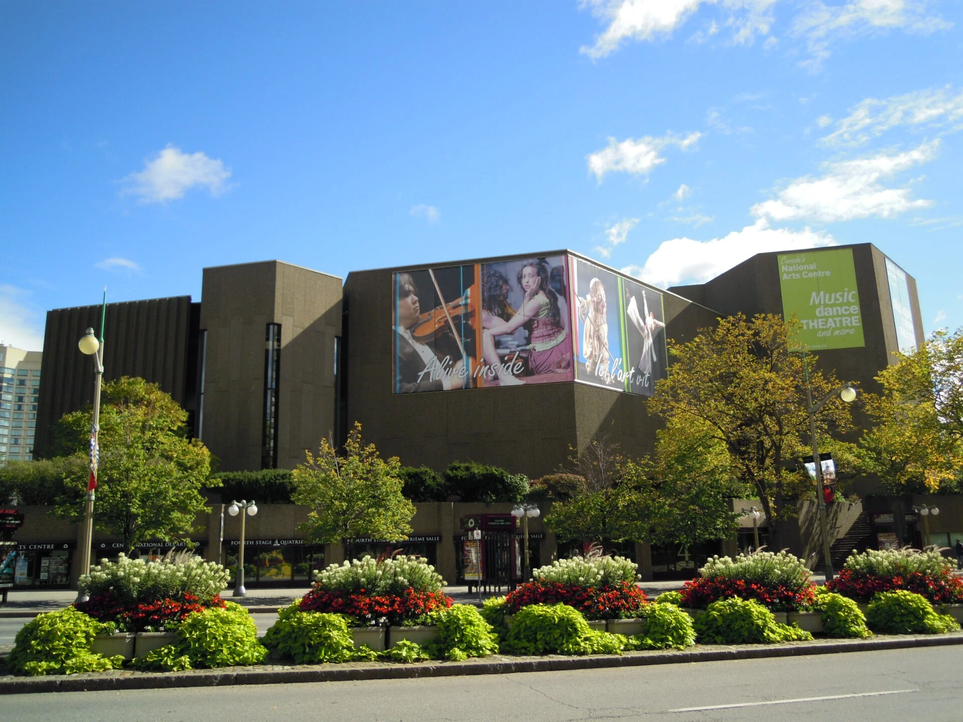 Illustrated exterior view of the National Arts Centre in Ottawa with autumn foliage.