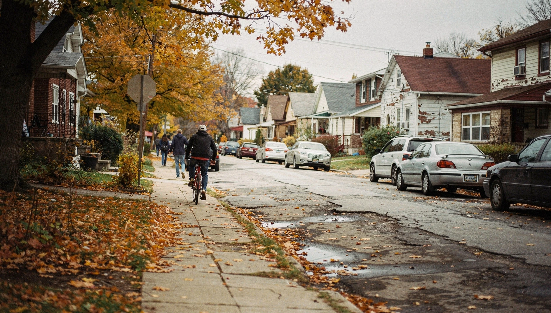 A residential street in Niagara Falls with suburban houses and parked cars under an autumn sky.