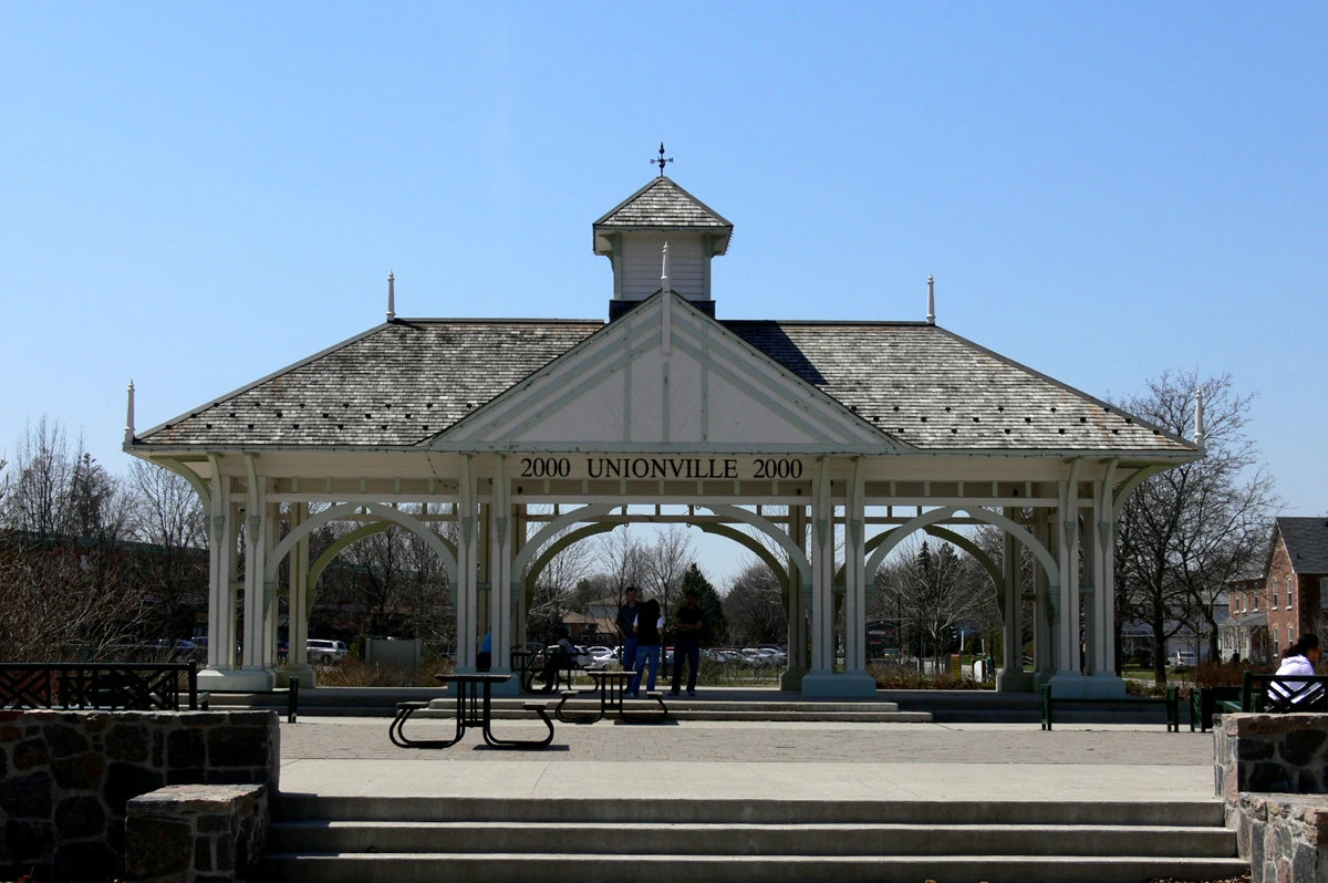 Illustration of an outdoor bandstand surrounded by leafy trees in Unionville.