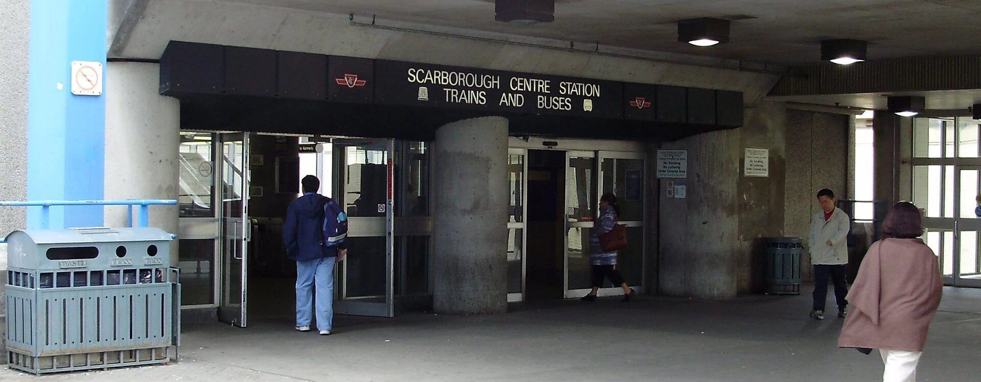 A transit bus at a station platform with traffic cones marking a closed bay at a Canadian bus terminal.