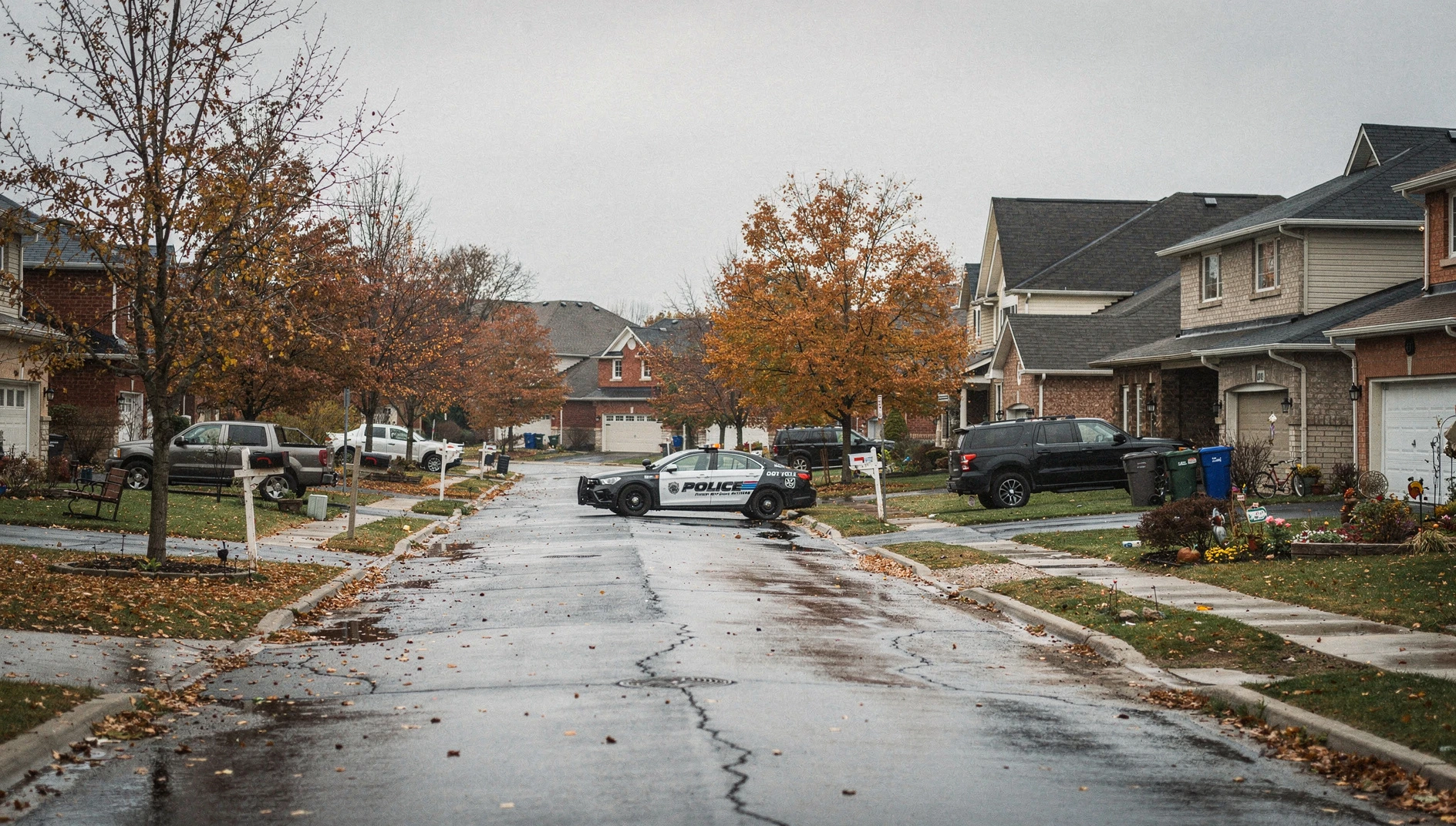 A police vehicle parked on a quiet residential street lined with autumn trees in a suburban Ontario neighbourhood.