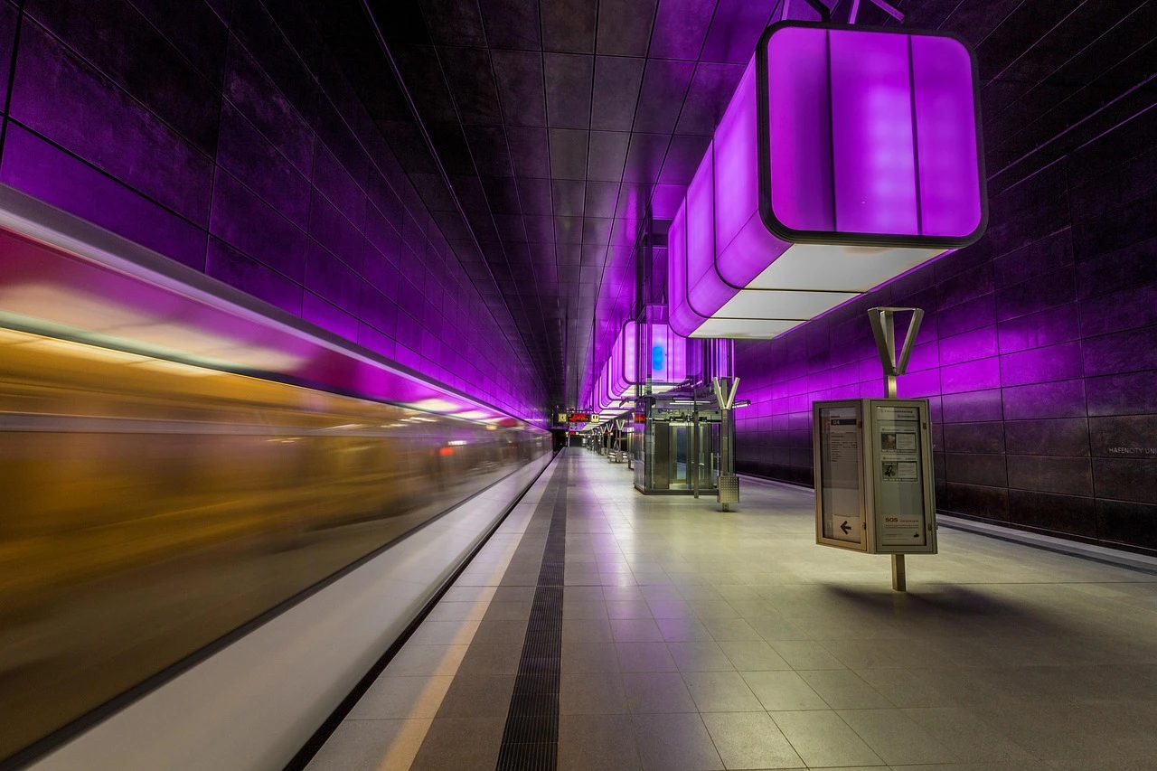 An Ottawa LRT train at a station platform on a summer morning.