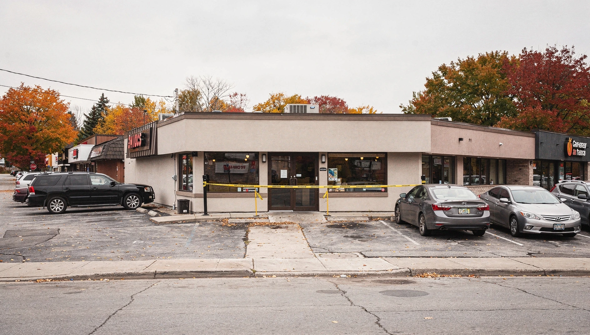 Illustration of a restaurant exterior behind police tape on an autumn day in Niagara Falls.