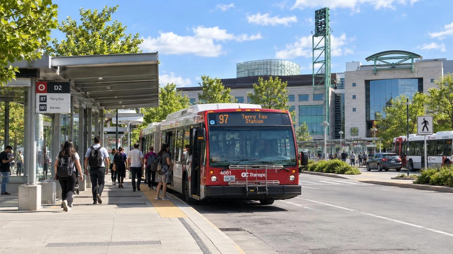 A close-up of a modern articulated transit bus at a city stop during a sunny summer day.