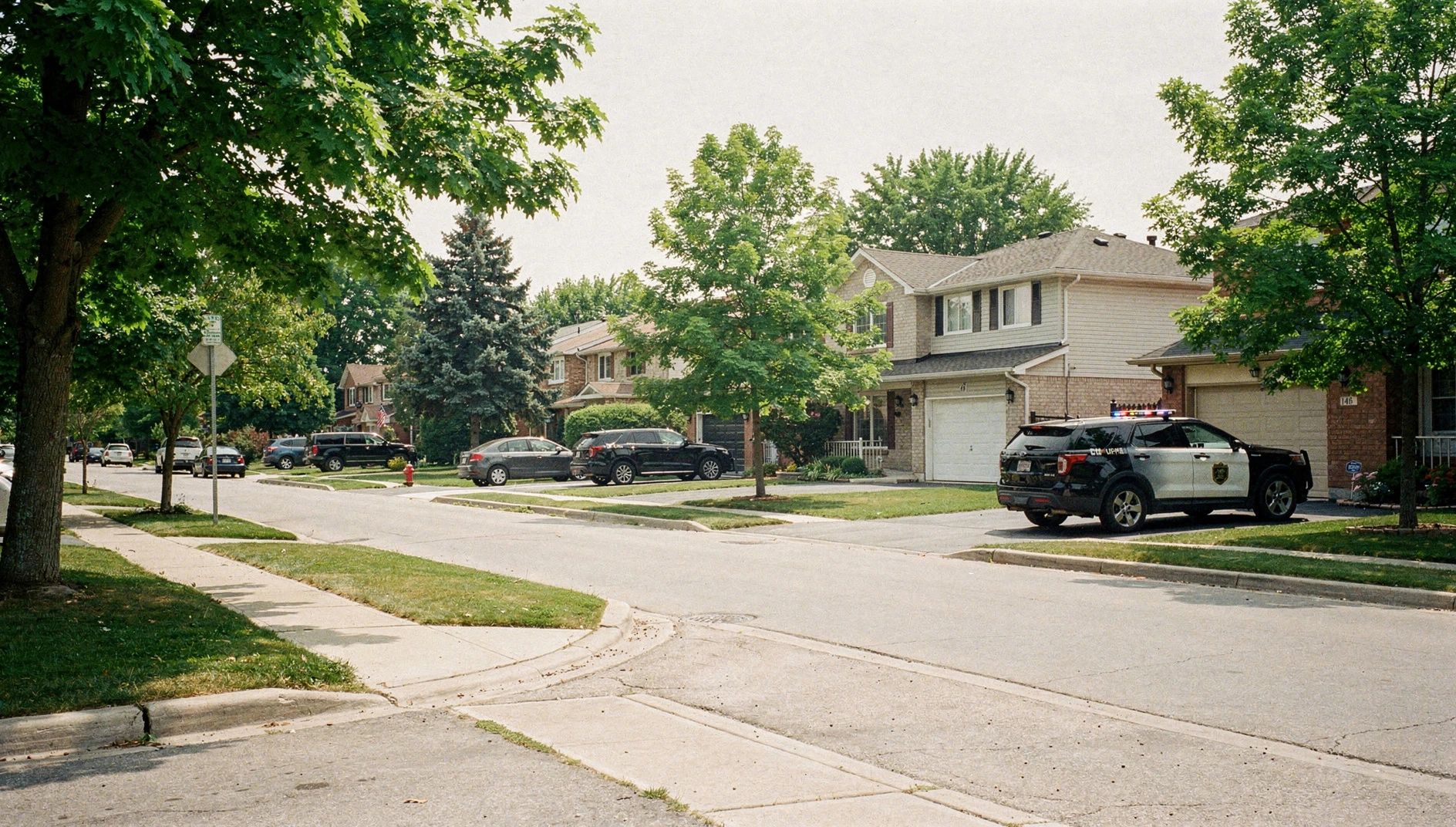 Illustration of an unmarked vehicle parked along a leafy suburban street in Mississauga.