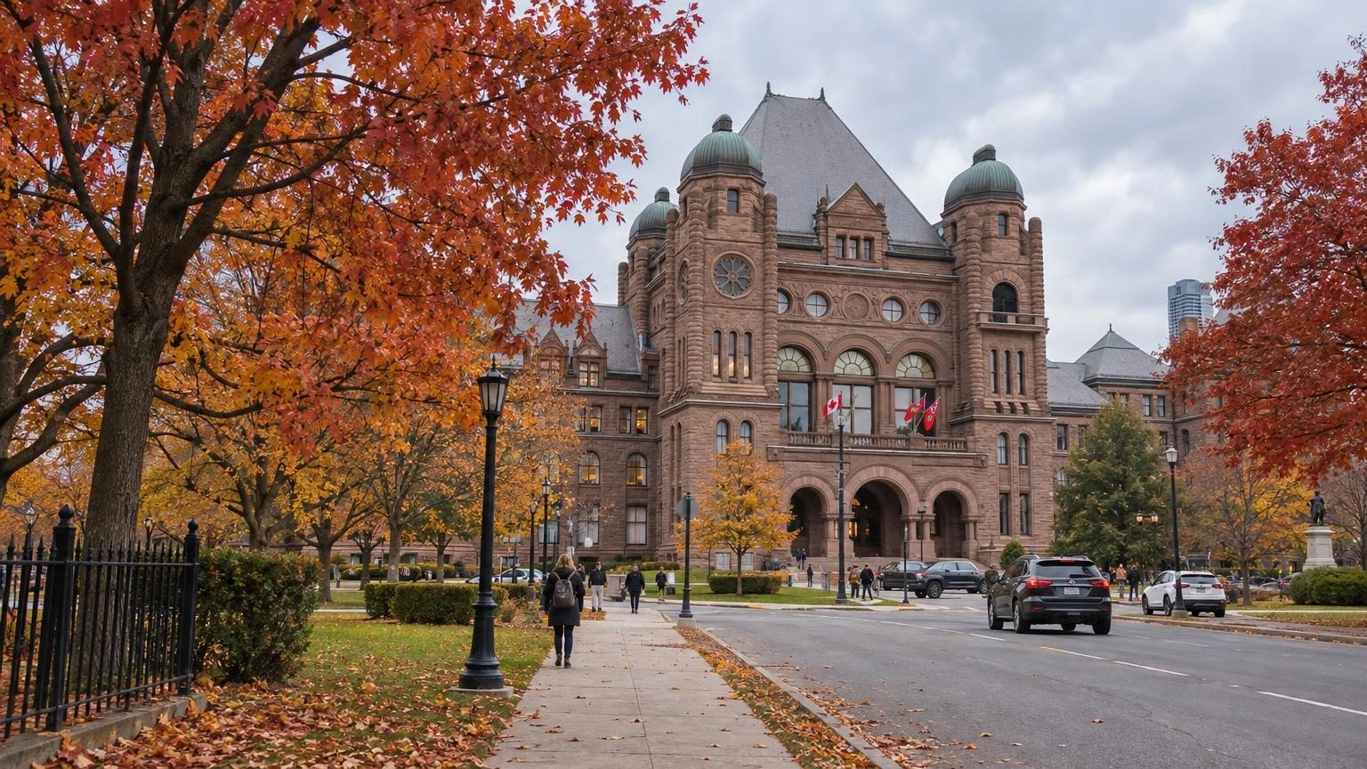 The Ontario Legislative Building at Queen's Park in Toronto surrounded by trees in autumn colour.