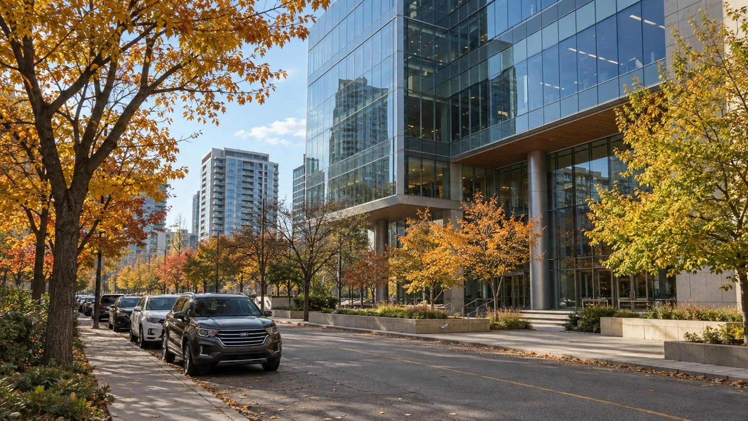 A modern office building exterior in a Toronto business district during autumn.