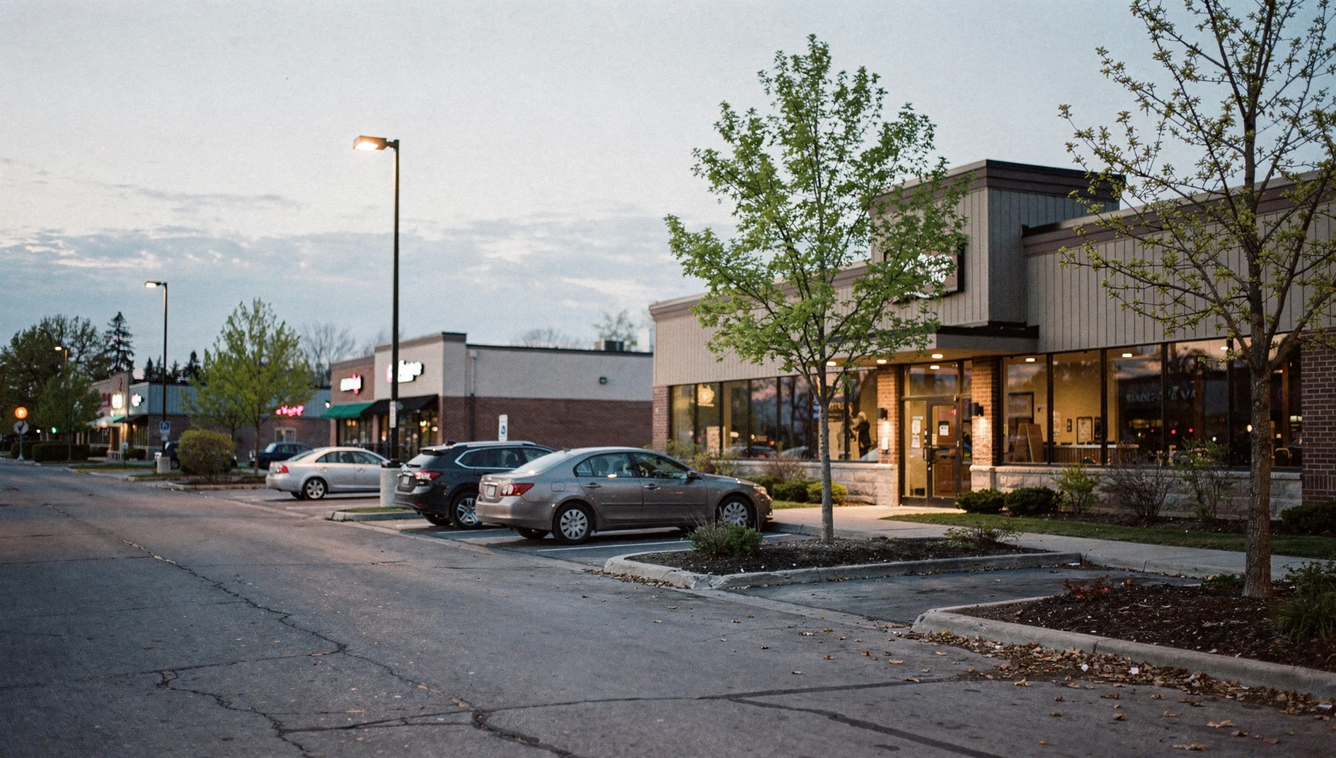 A street view of a commercial plaza in Ajax, Ontario, during a spring evening.