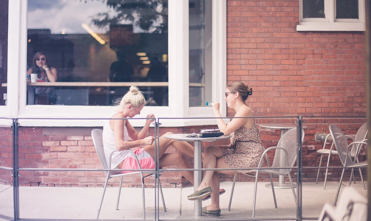 Illustration of an outdoor restaurant patio in Markham in autumn, with an empty table and a purse hanging off the back of a chair.