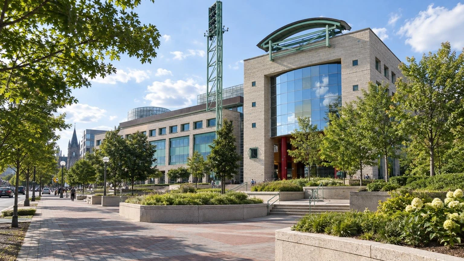 The exterior of Ottawa City Hall on a summer day, with its plaza and landscaped grounds.